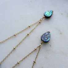 Load image into Gallery viewer, The Abalone Leaf necklace's pendant hangs on a gold stainless steel chain.