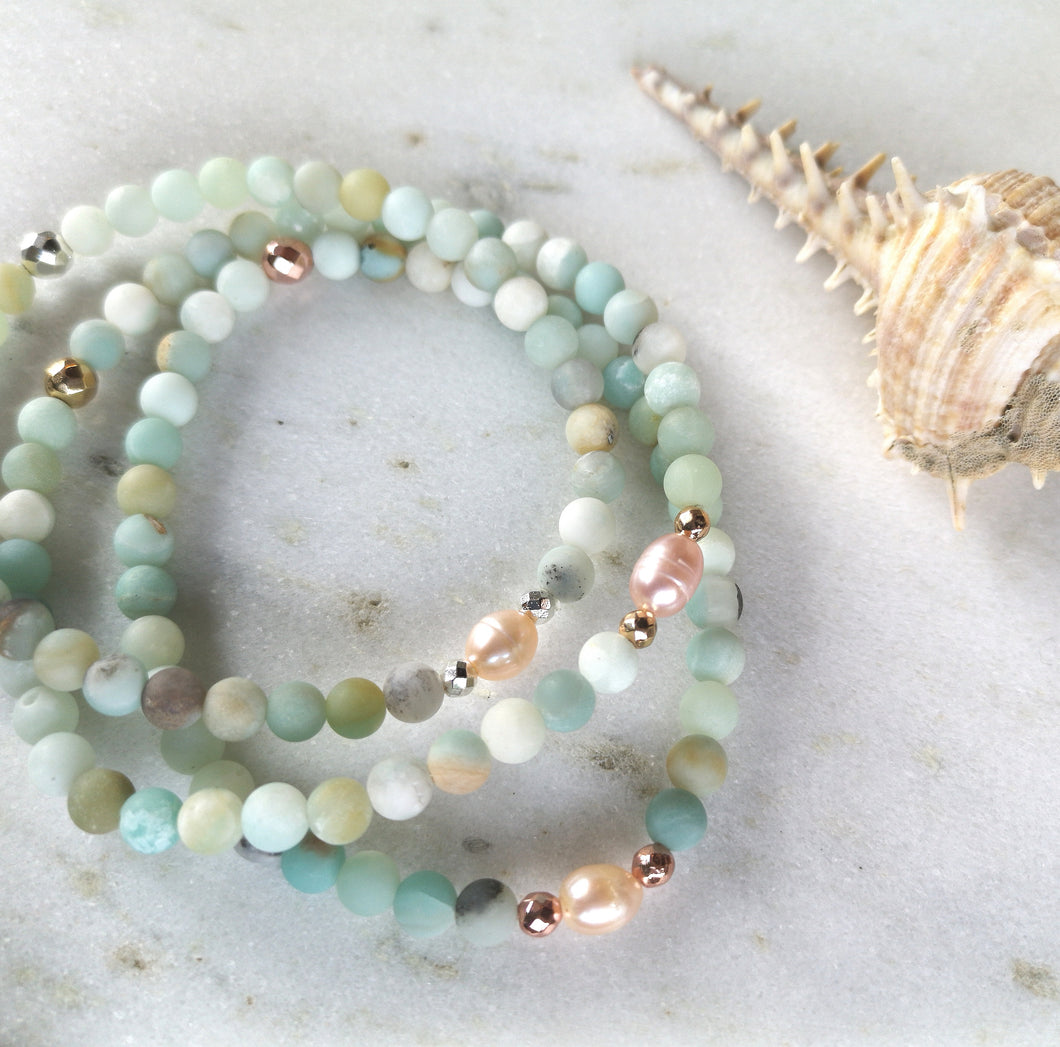 Three amazonite and pearls beaded anklets on a white background.