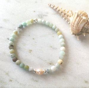 An amazonite and pearls beaded anklet with silver accents on a white background.